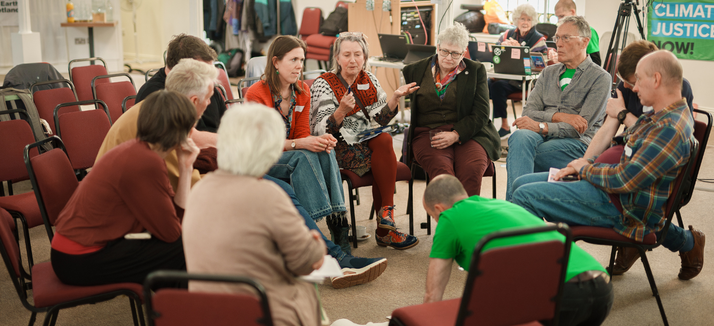 A group of people are shown sat on a circle of chairs, talking. Picture: Friends of the Earth Scotland